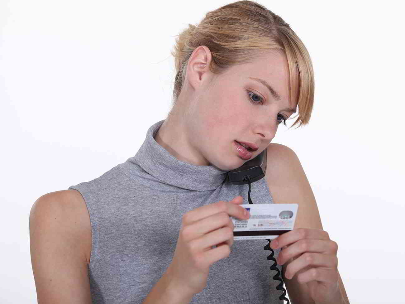woman examining credit card