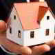 hand holding house