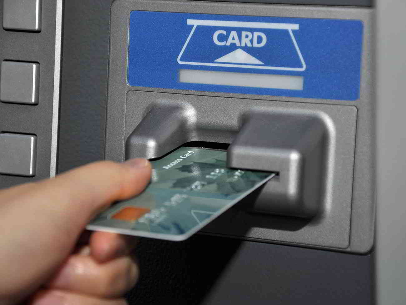 woman putting card in atm