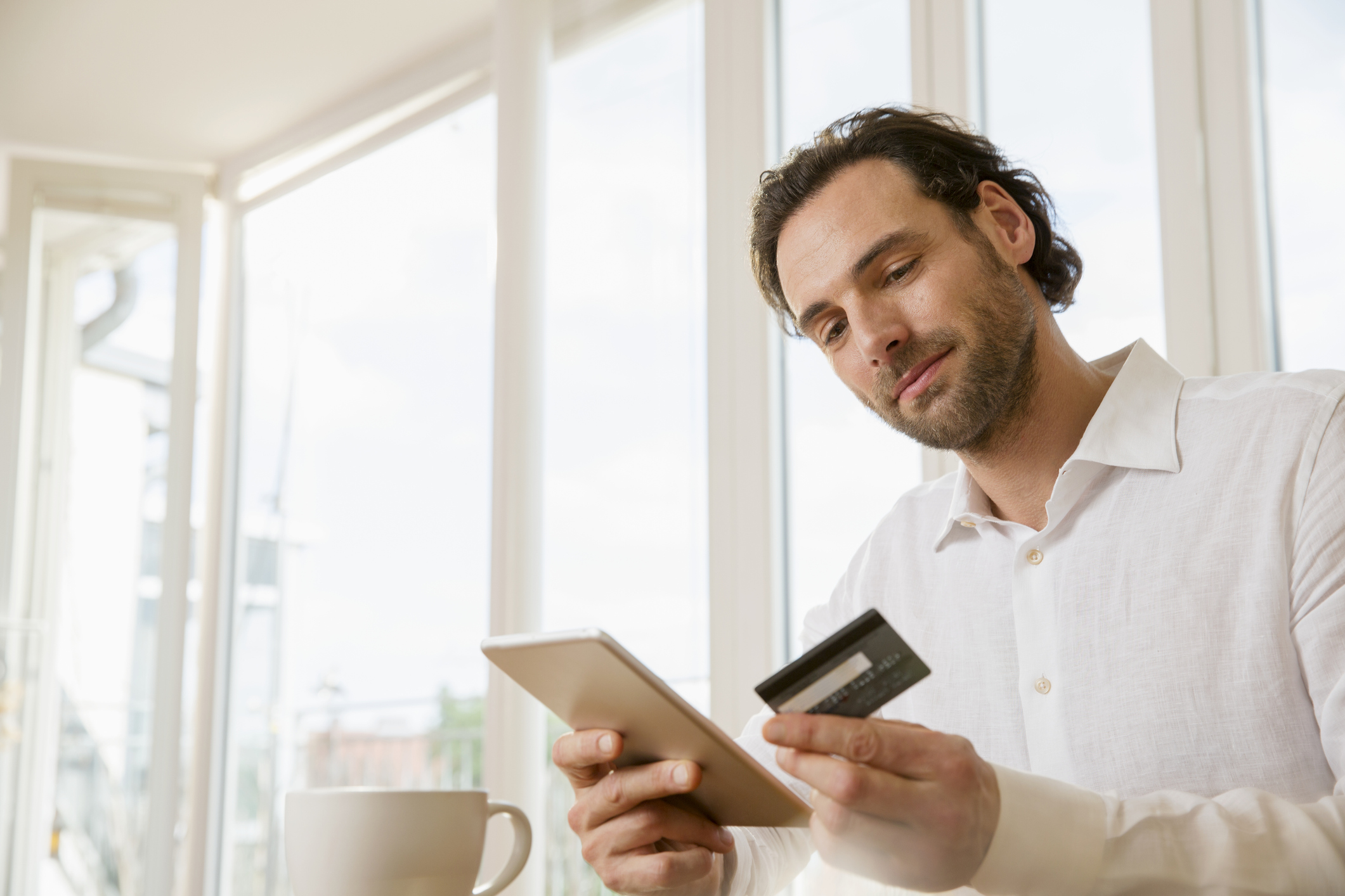 A man contemplates using his credit card or applying for a personal loan