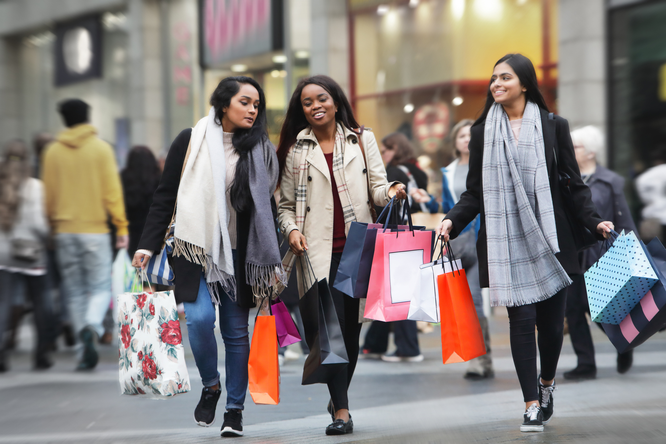 Women holding shopping bags on a shopping spree using their credit cards