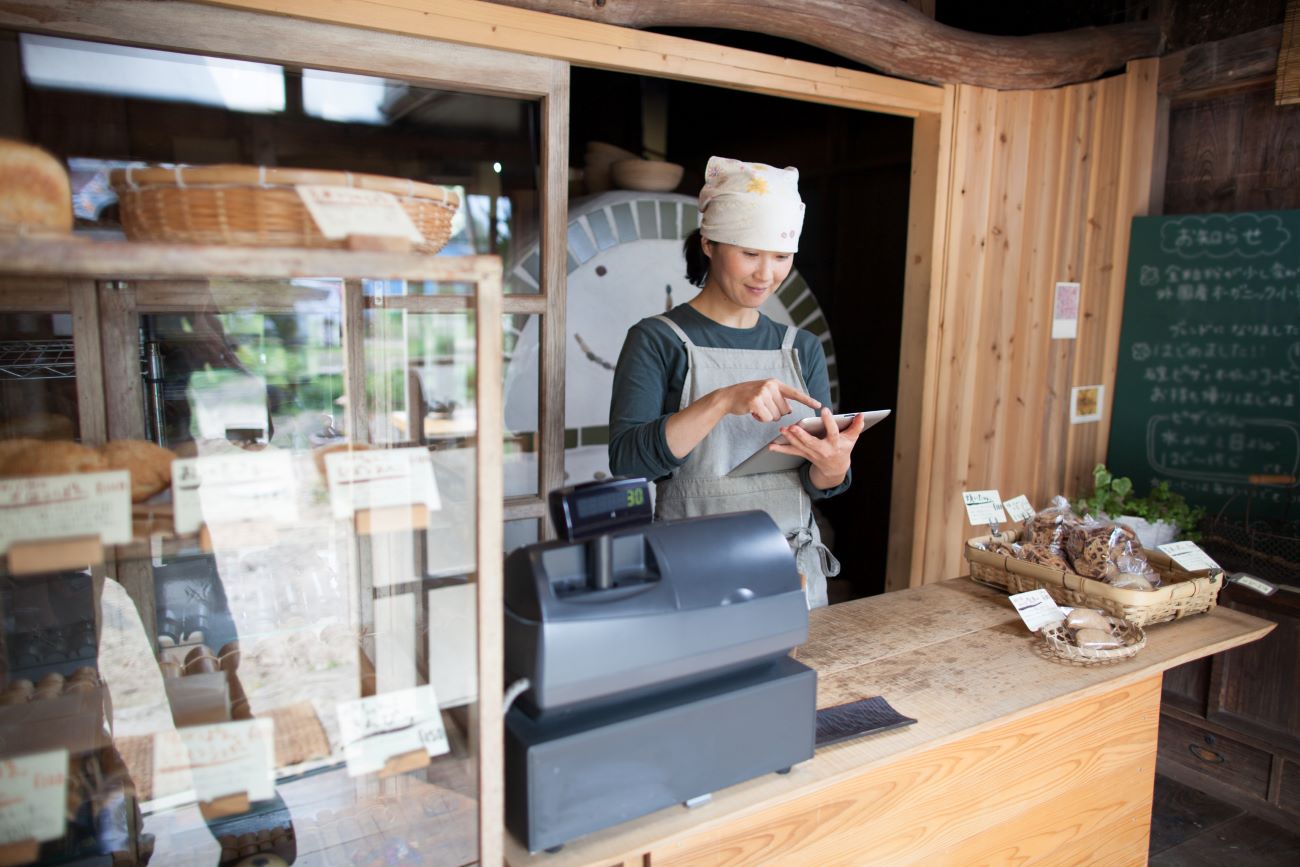 A small business owner applies for a personal business loan using her tablet