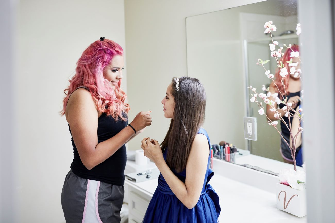 a young girl prepares for her quinceanera with help from her older sister