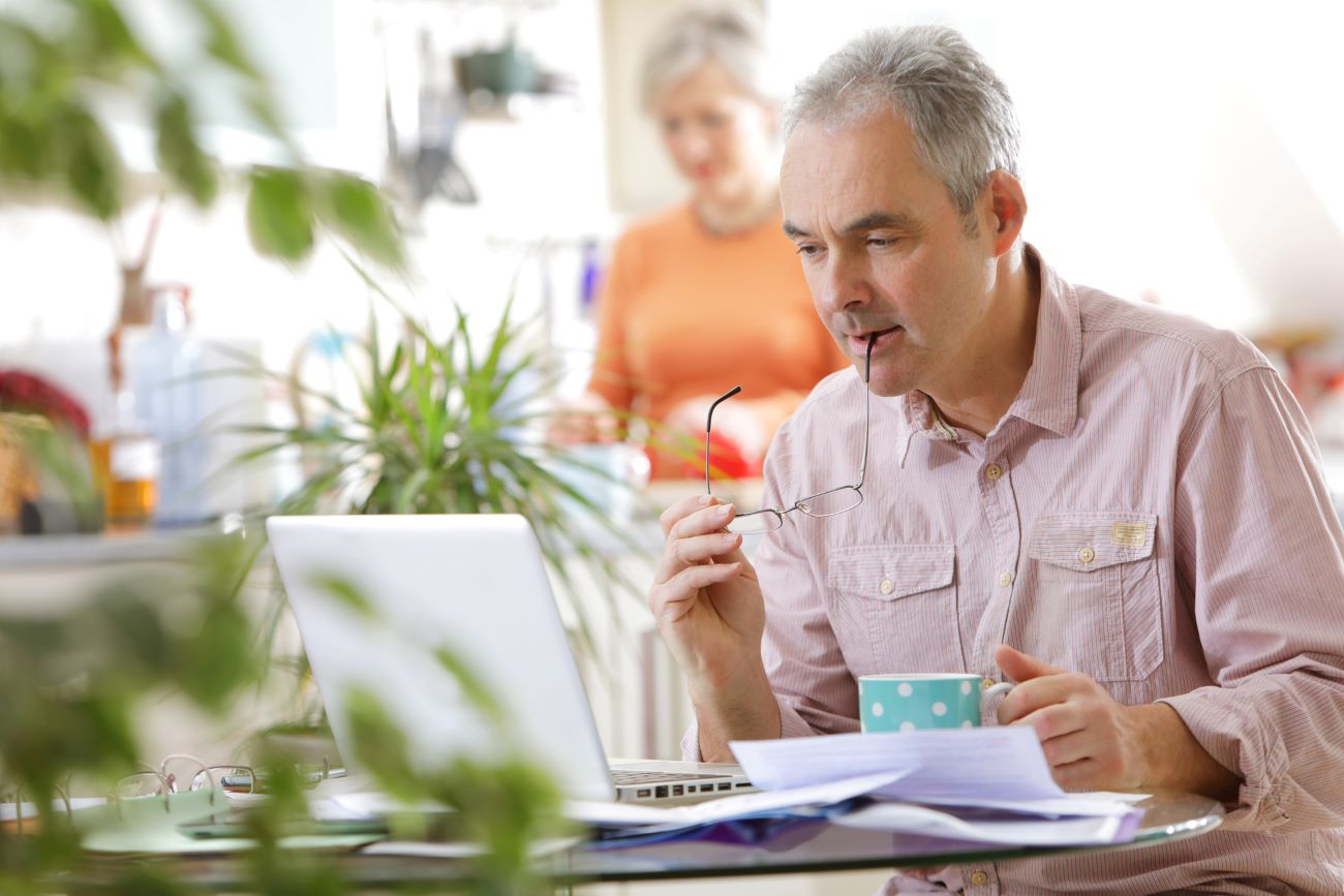 a man works on his computer to fix his credit after identity theft