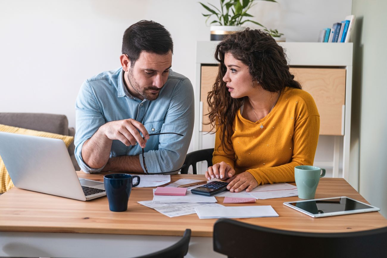 a couple looks at their finances to decide