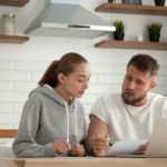 Focused serious couple are looking at their bills and personal line of credit