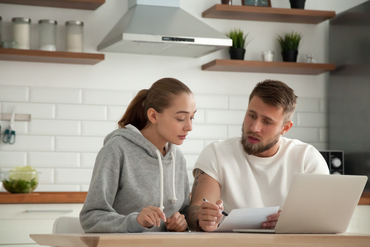 Focused serious couple are looking at their bills and personal line of credit