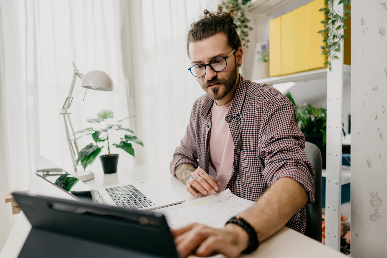 a man applies for a loan using his laptop computer