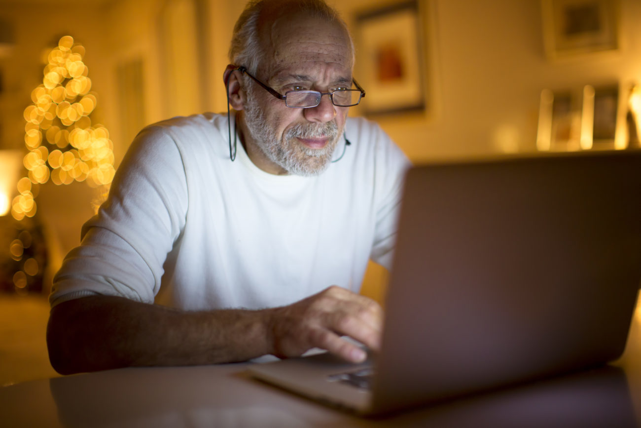 A man uses his computer to research his credit score