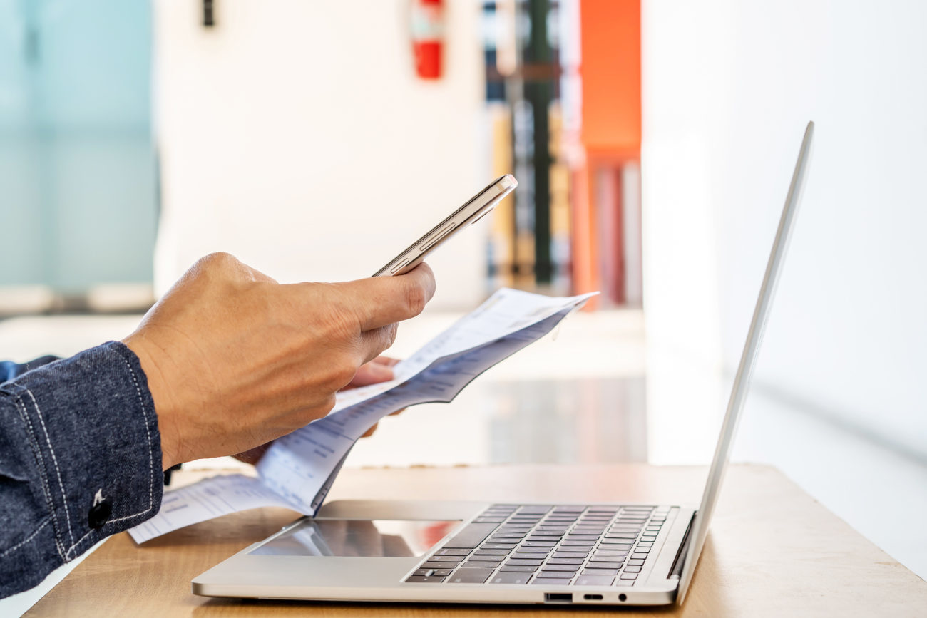 a man uses a mobile phone to apply for an Avant personal loan.