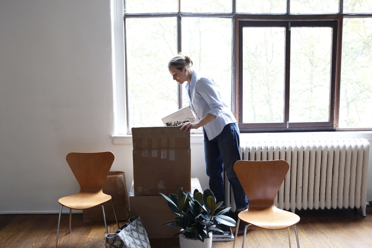 a woman is moving into the new home she purchased using a personal loan for a home down payment