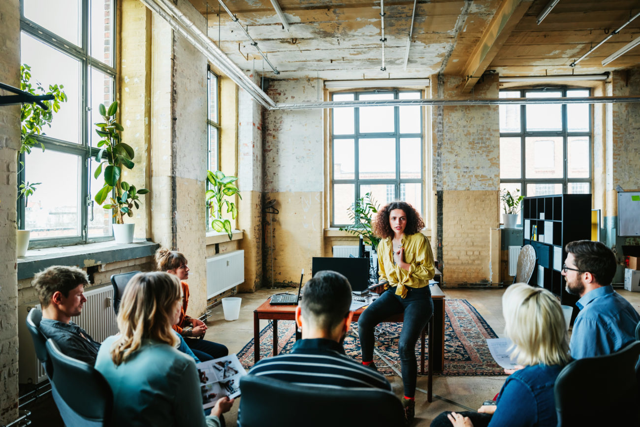 a group of people hold an informal meeting at a tech startup firm