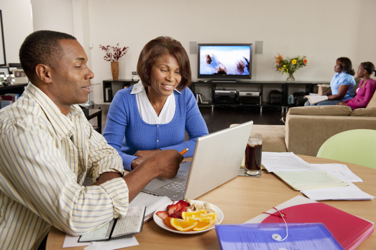 A married couple use their computer to apply for an Upgrade personal loan