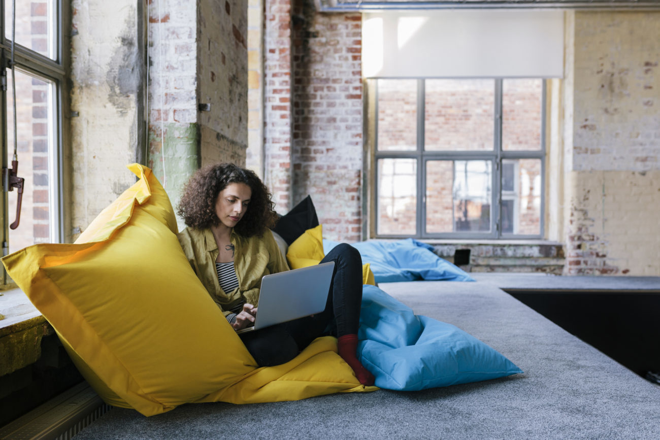 A woman looks at her computer to research different personal loan options