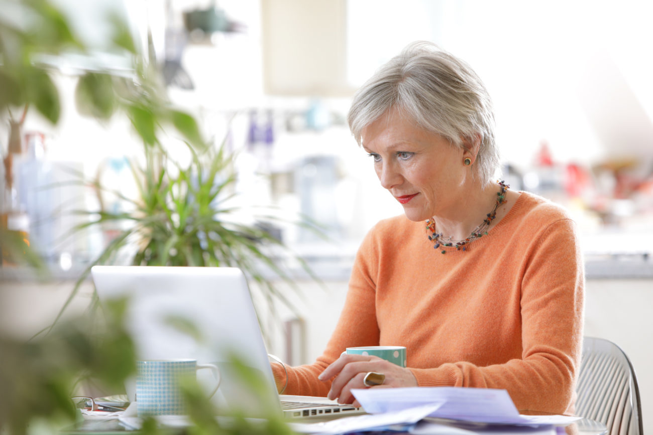 A woman is using her laptop to gather her documents to apply for a personal loan