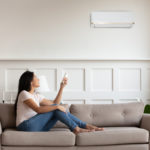 A woman enjoys her new air conditioning unit paid for with a home improvement loan