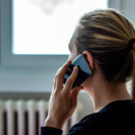 A worried woman talks on phone about emergency loan