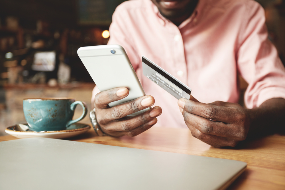 Man in casual shirt paying with credit card