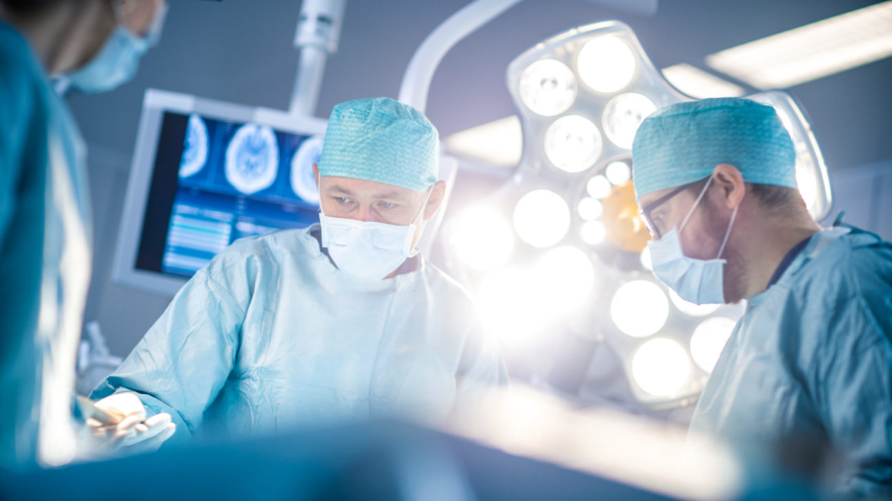 Surgeons in an operating room taking care of a patient